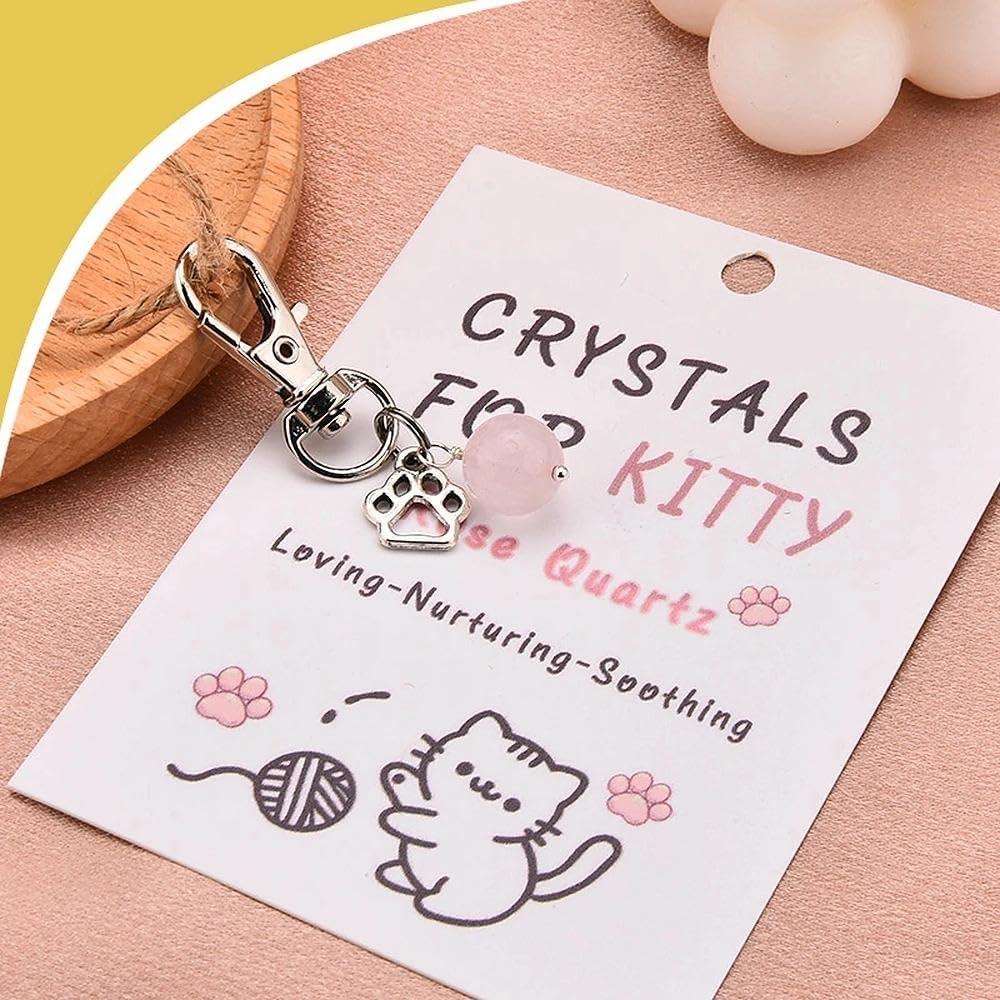 Rose quartz crystal charm on decorative kitten necklace card.