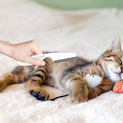 Pet grooming comb held in hand for size reference