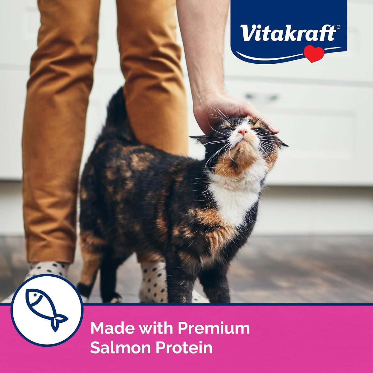 Cat enjoying Vitakraft Lick N Lap liquid treat from a squeeze tube