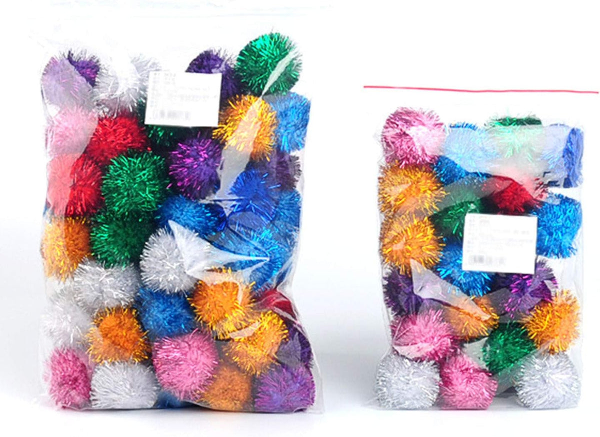 Two inch soft bouncy sparkle ball for cats held in hand to show size scale