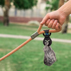 Hands free dog walking accessory holding a knotted plastic waste bag securely