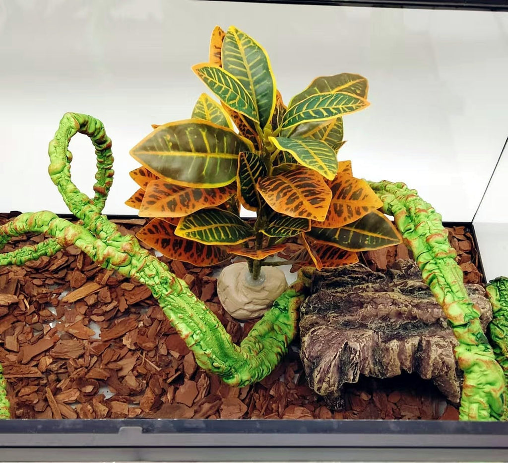 Keruideng artificial foliage arranged inside a glass reptile enclosure