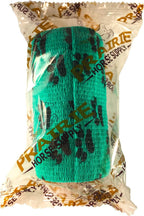 Close up of teal bandage with black paw print pattern