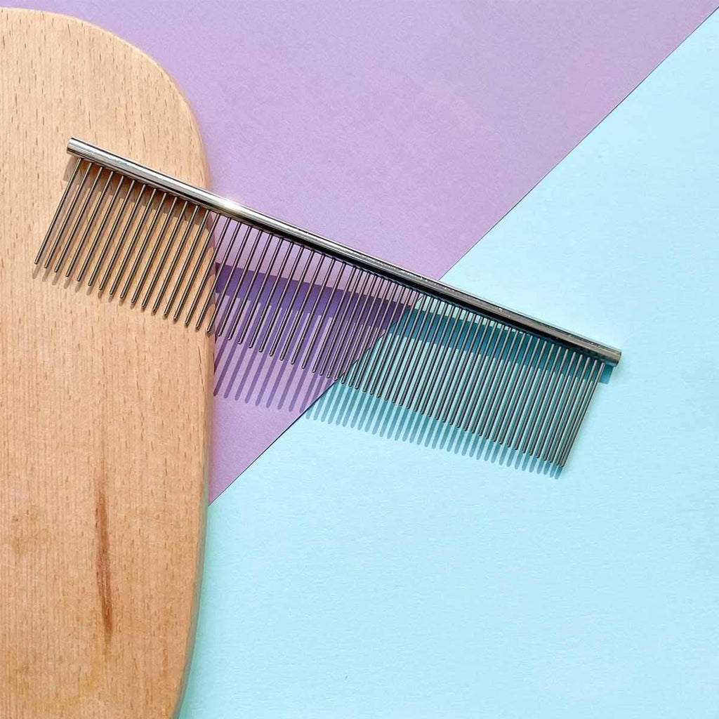 Stainless steel teeth close up of cat undercoat rake for shedding control