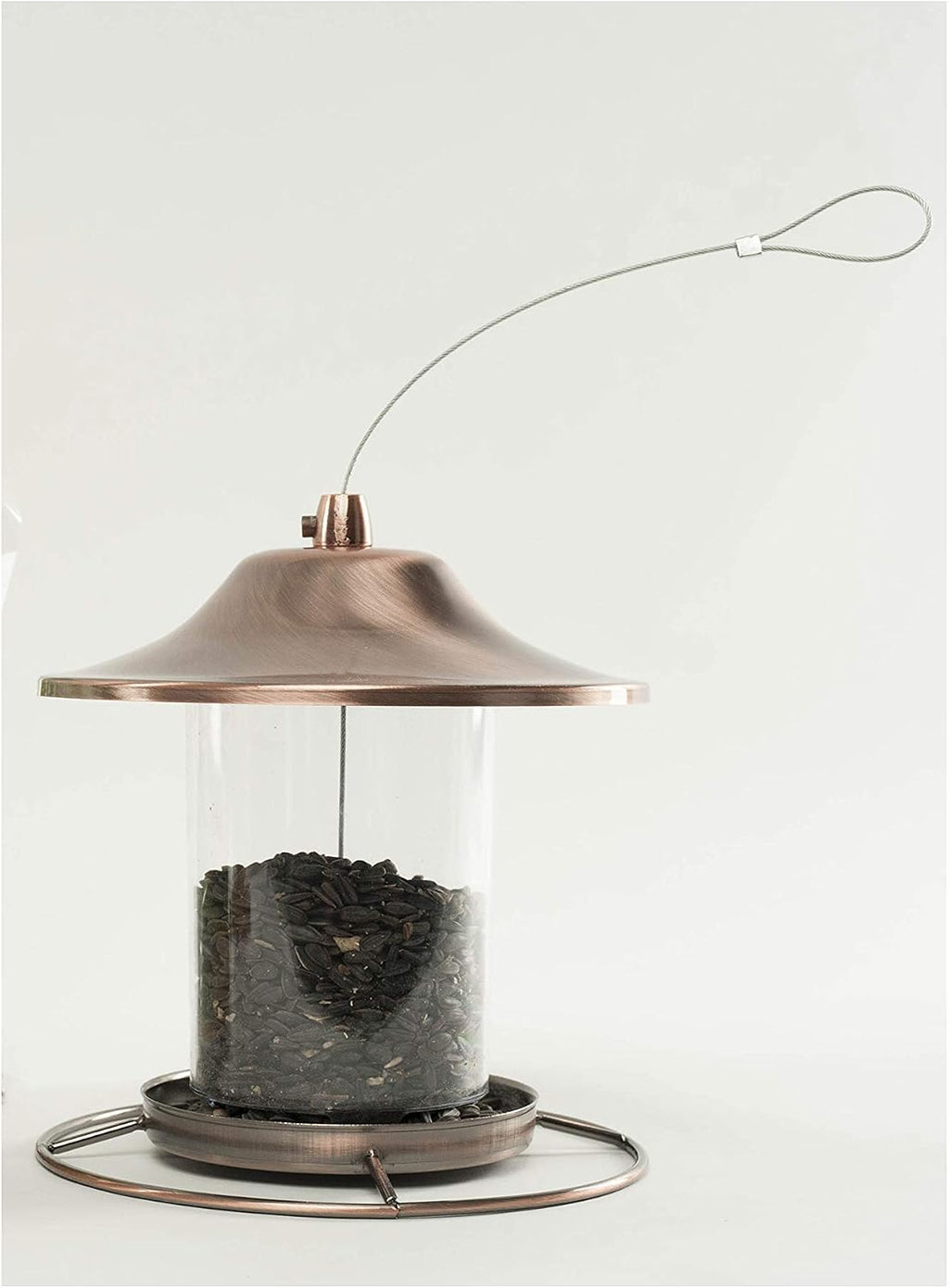 Various wild birds gathering around a tray feeder filled with black oil seeds