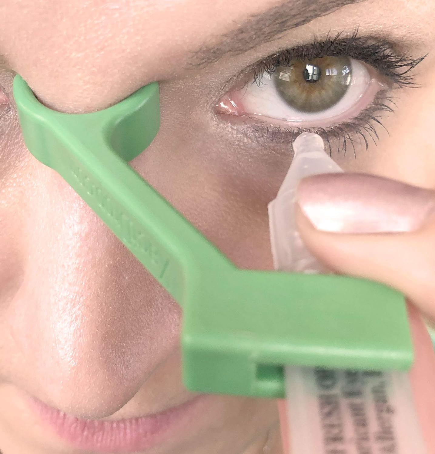 XactDrop single use narrow eye drop applicator front view showing green silicone bracket design