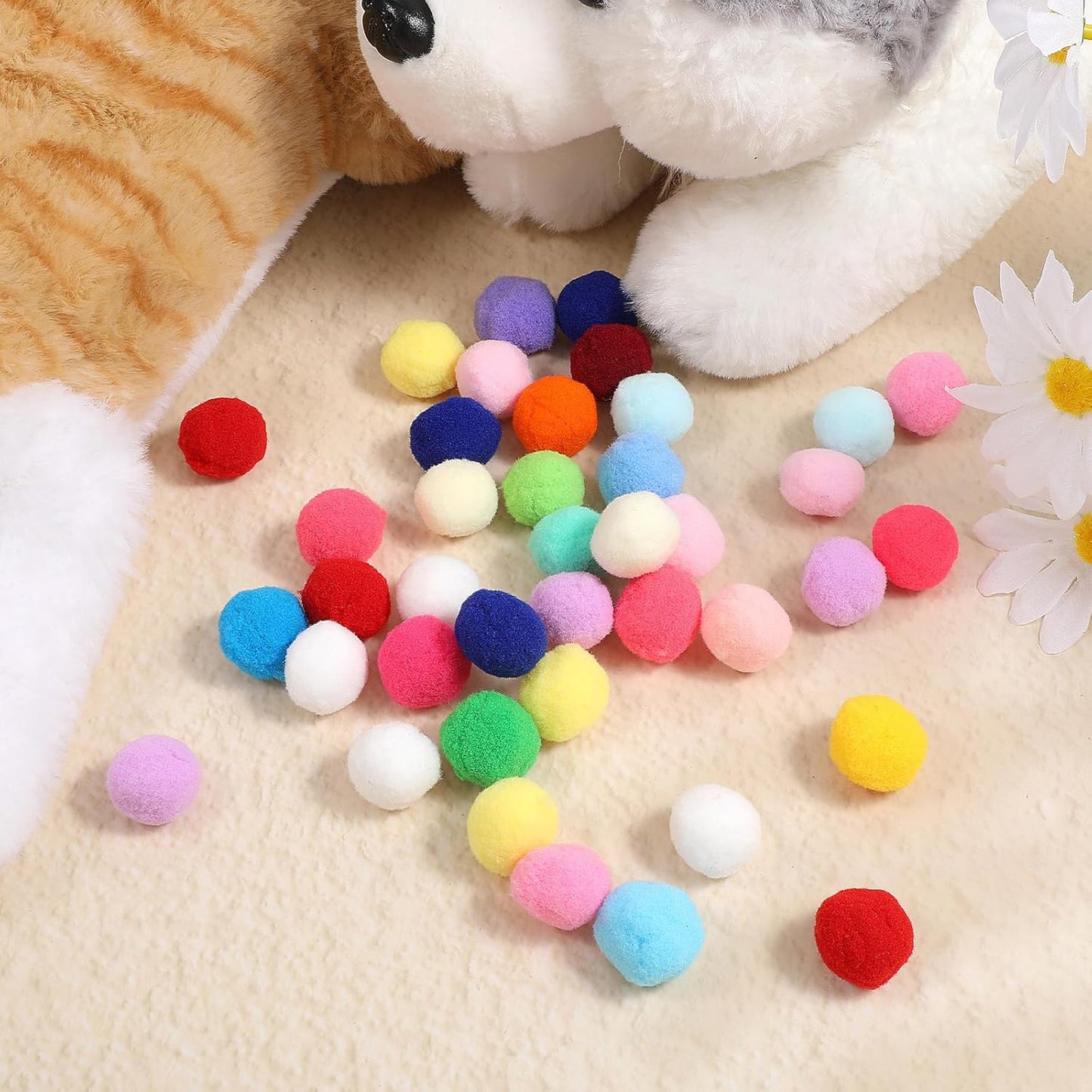 Cat playing with colorful interactive pom pom toy balls
