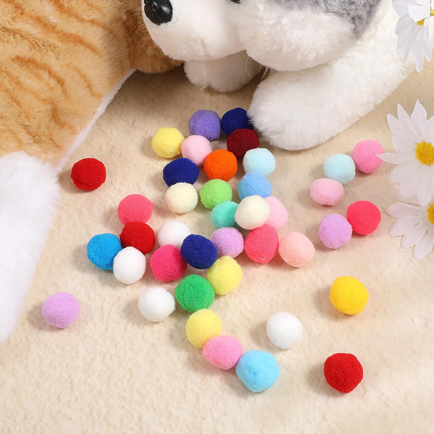 Cat playing with colorful interactive pom pom toy balls