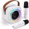 EGivwcvic mini karaoke machine for kids showing the front view of the white speaker with a leather handle and two matching wireless microphones
