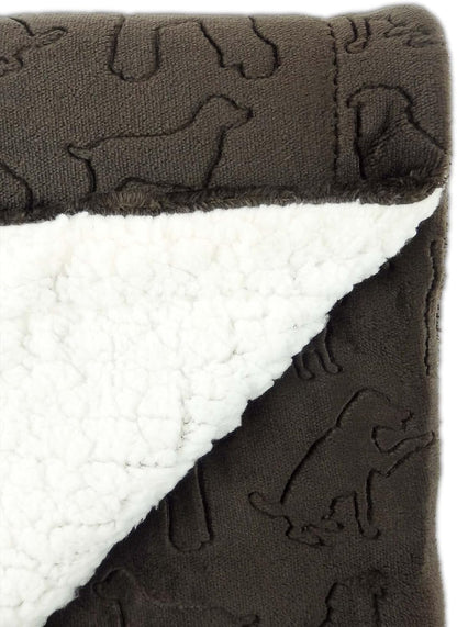 Machine washable premium pet blanket being unfolded for use on a master bed