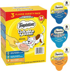 Adult cat licking a Temptations creamy purÃ©e treat directly from the plastic spoon