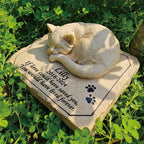 Close up of the three dimensional sleeping kitty statue on resin stone.