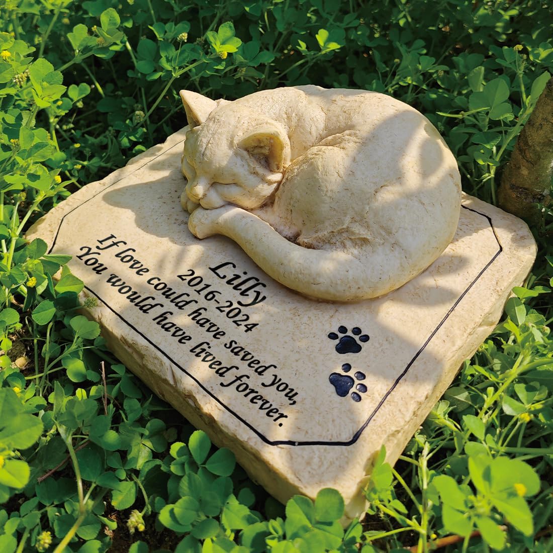 Close up of the three dimensional sleeping kitty statue on resin stone.