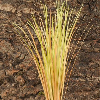 Artificial desert grass plant inside a bearded dragon tank