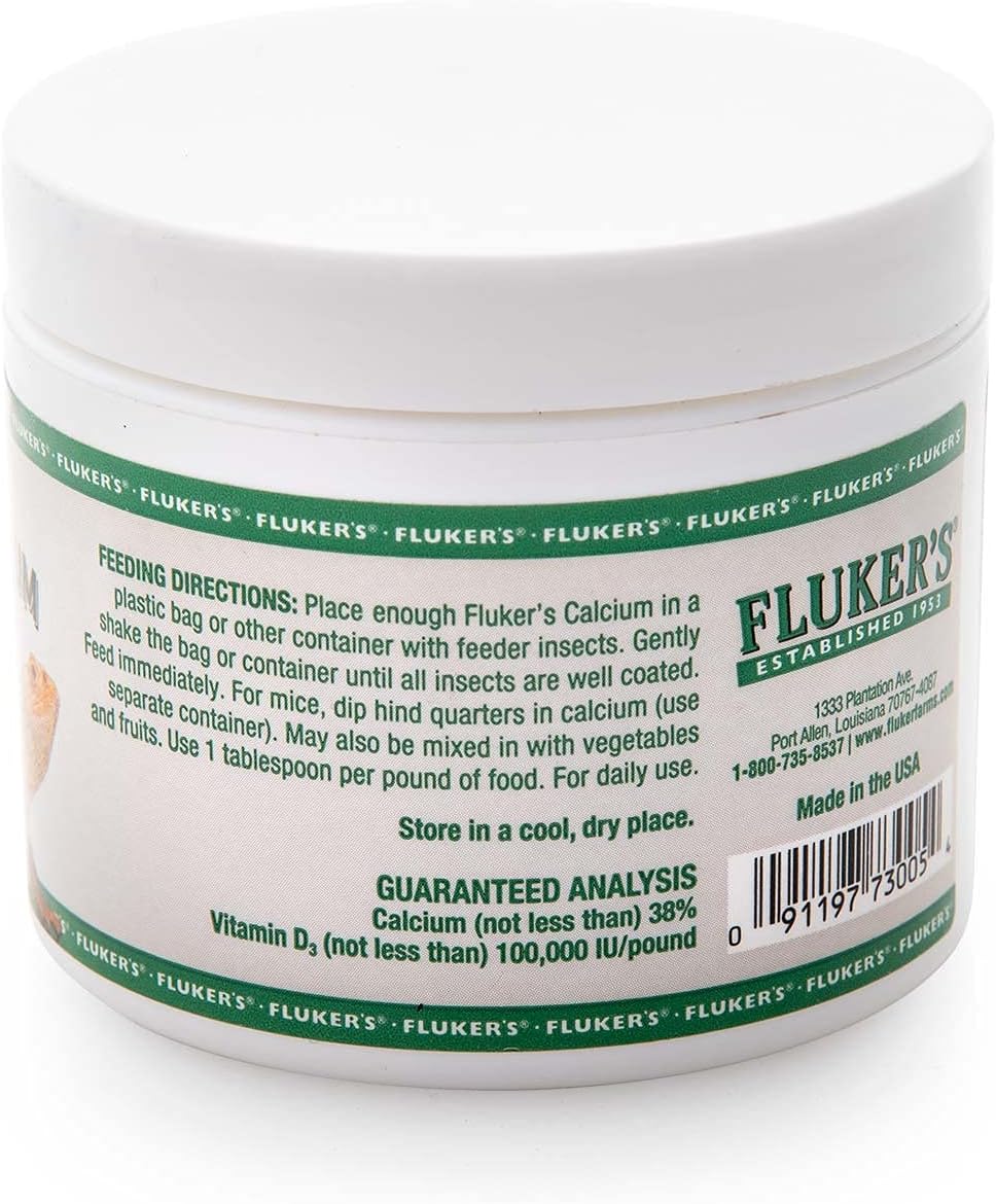 Fluker's reptile supplement container held in hand for scale