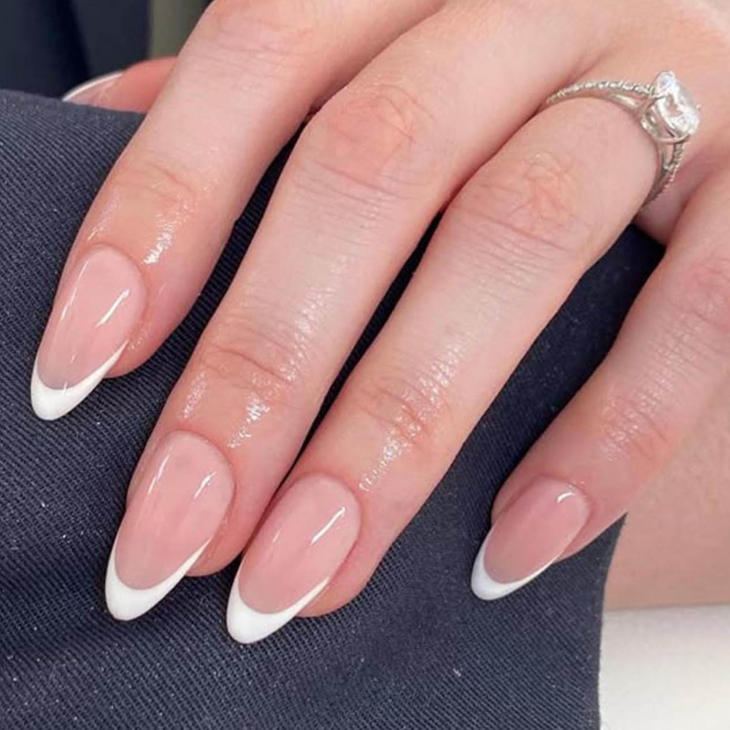 Modelones French tip press on nails in a short almond shape for a classic look