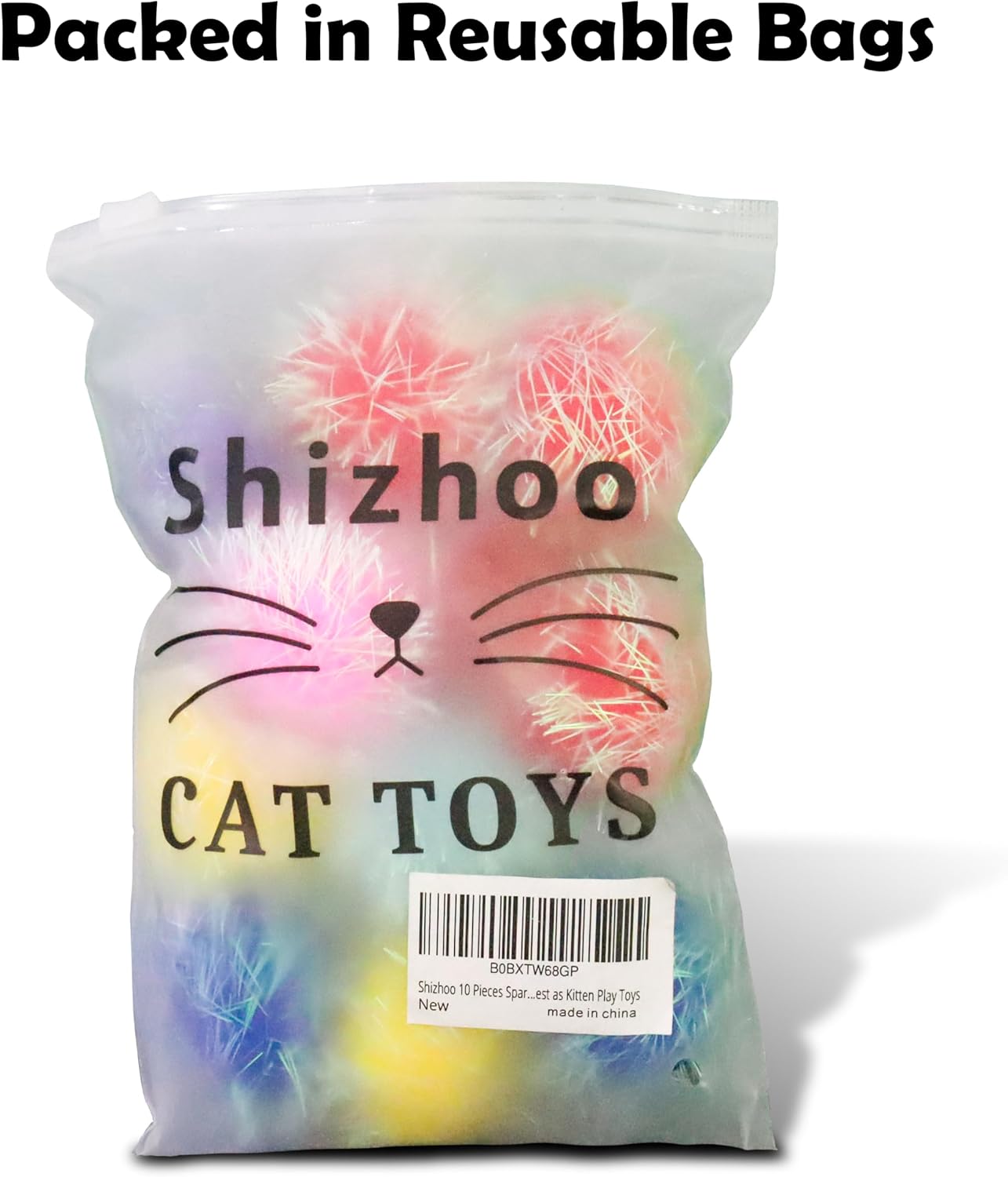 Assorted pile of one point two inch fuzzy kitten play toys scattered on a clean surface.