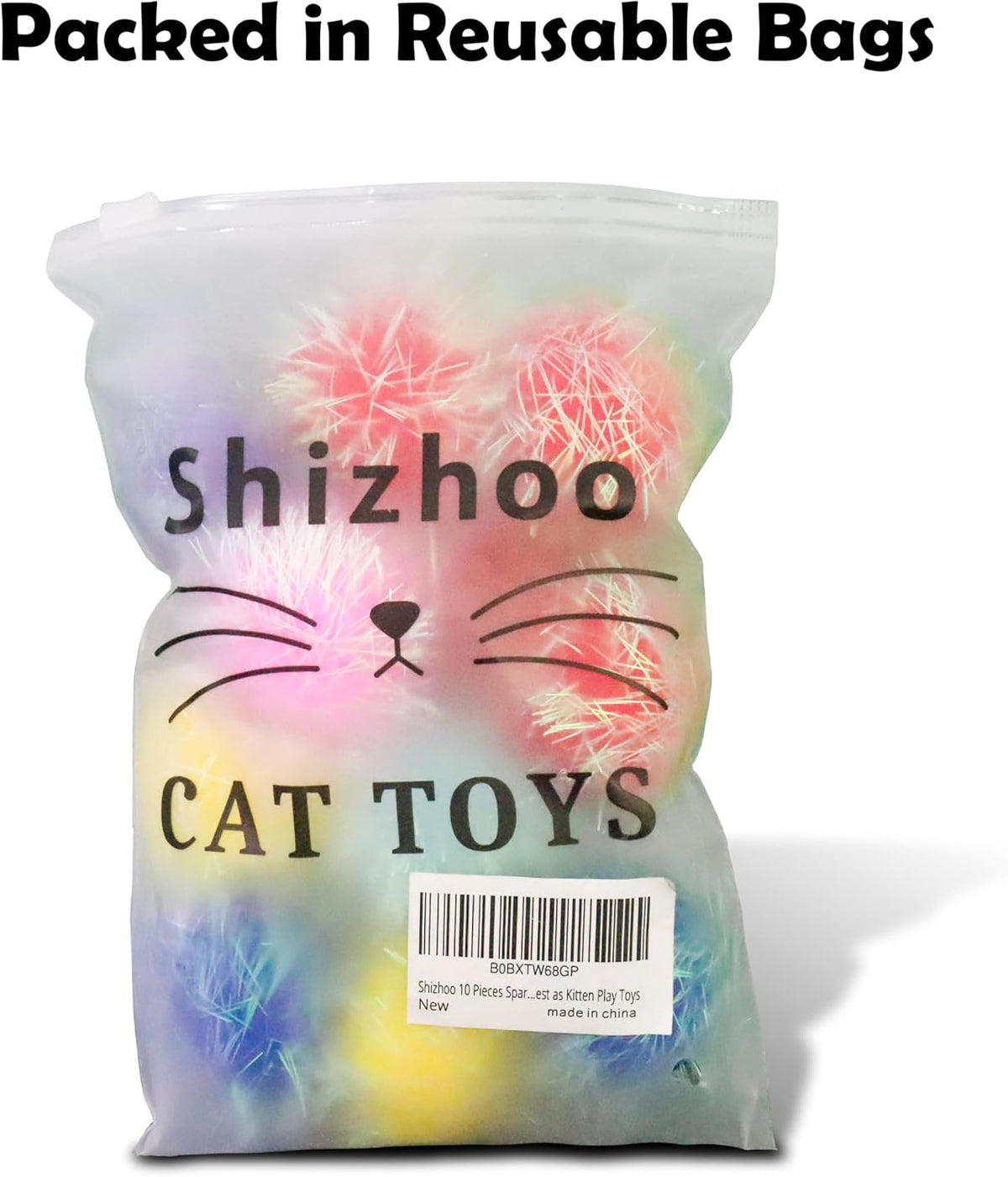 Assorted pile of one point two inch fuzzy kitten play toys scattered on a clean surface.