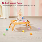 Kitten pouncing on colorful quiet felt ball toy