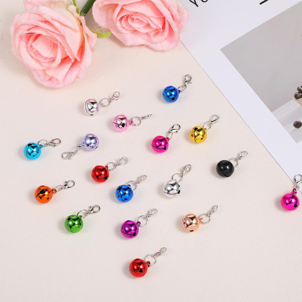 Assorted vibrant mini pet jingle bells displayed together to show the compact sizing and variety.