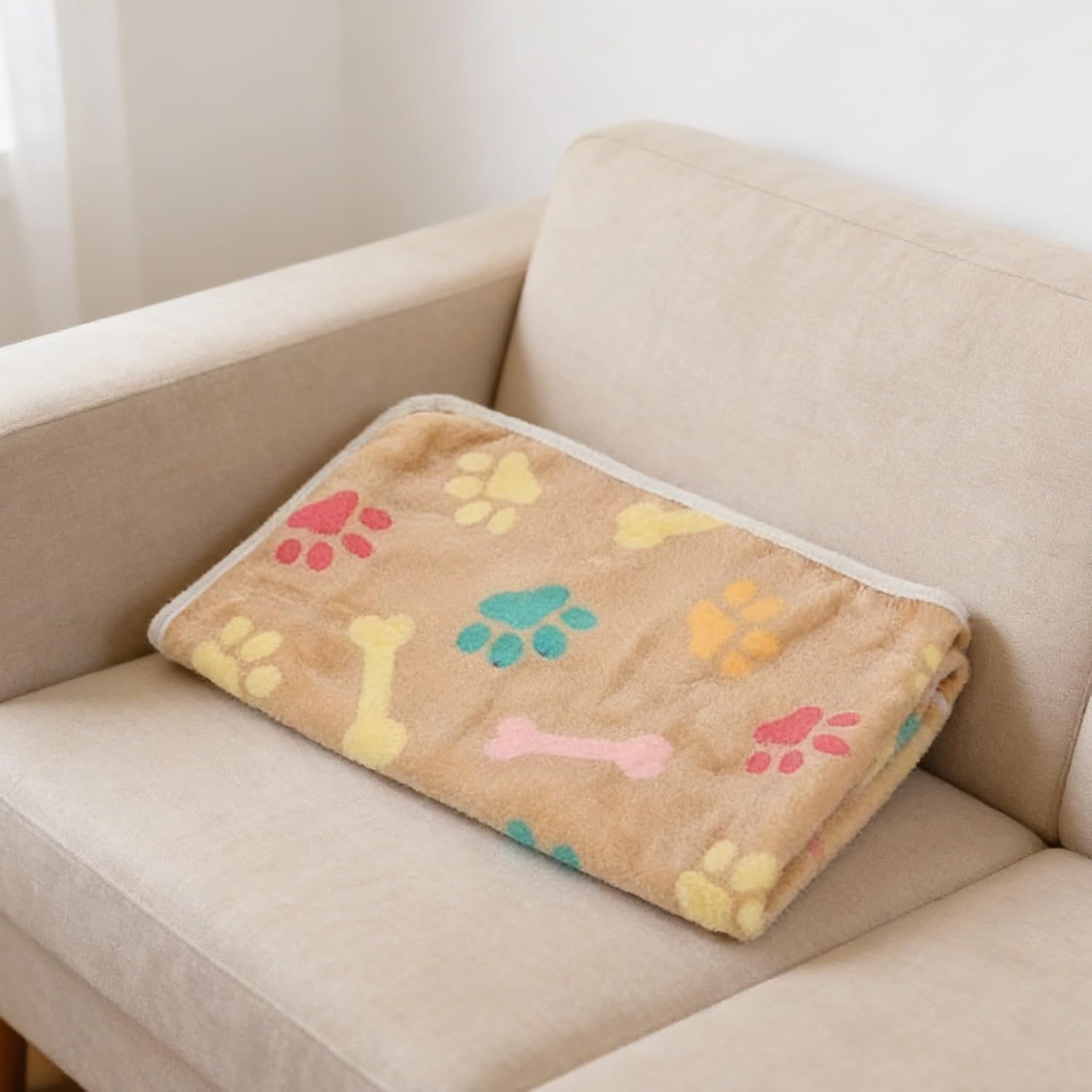 Lightweight puppy blanket spread across a modern domestic pet bed.