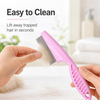 Ergonomic grip pink pet comb for cleaning paws and eyes.