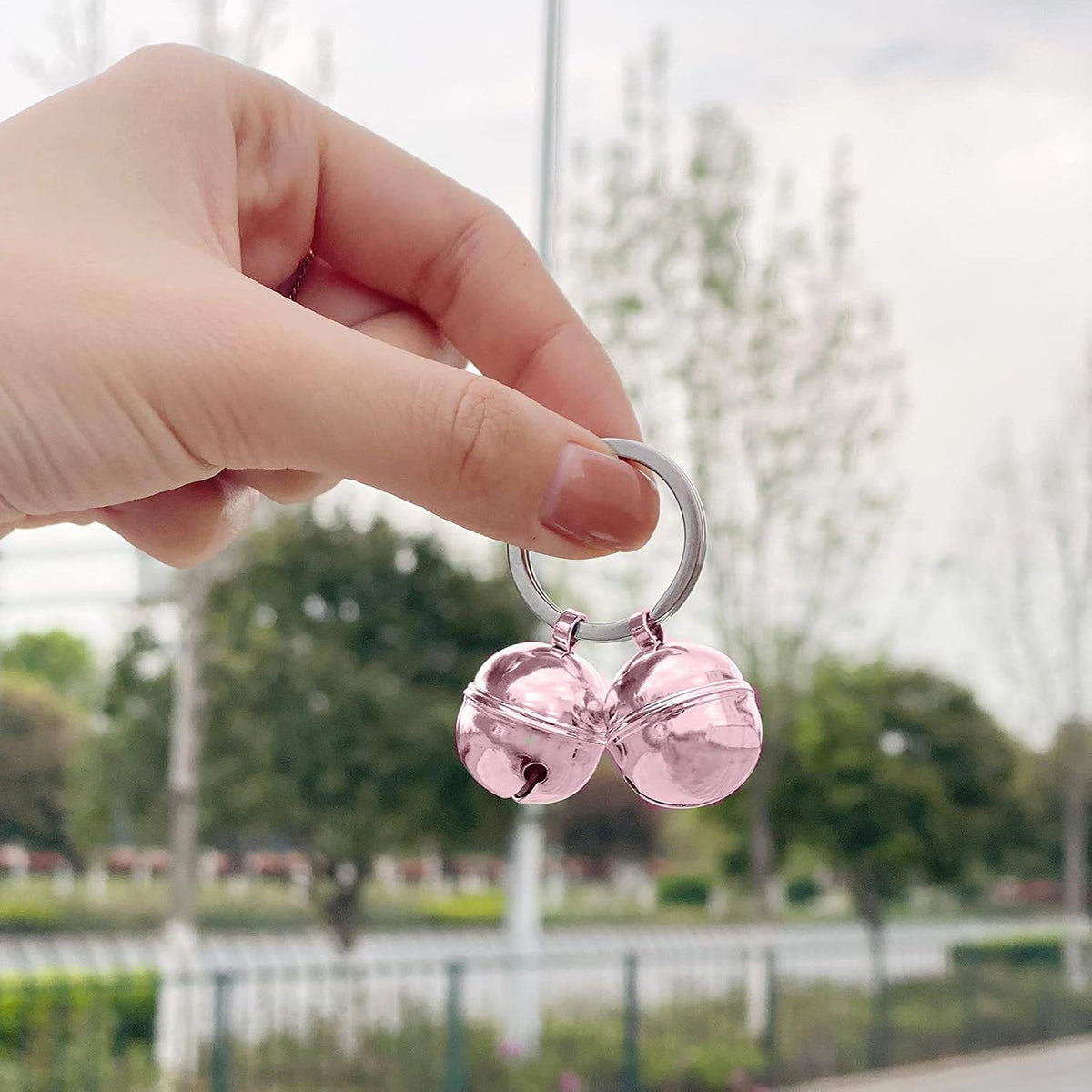 Handmade rust proof pink cat collar bells showcasing the 0.8 inch diameter metal design.