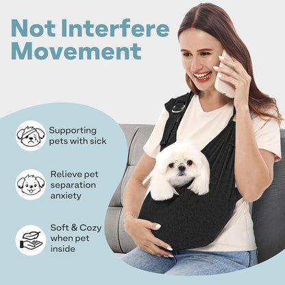 Small dog resting comfortably in black cotton pet sling