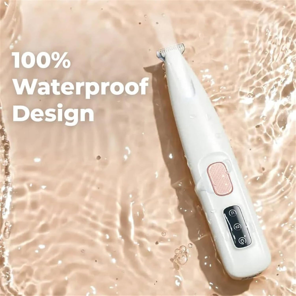 Waterproof rechargeable cat grooming tool being rinsed under running water for easy cleaning.