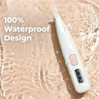 Waterproof rechargeable cat grooming tool being rinsed under running water for easy cleaning.