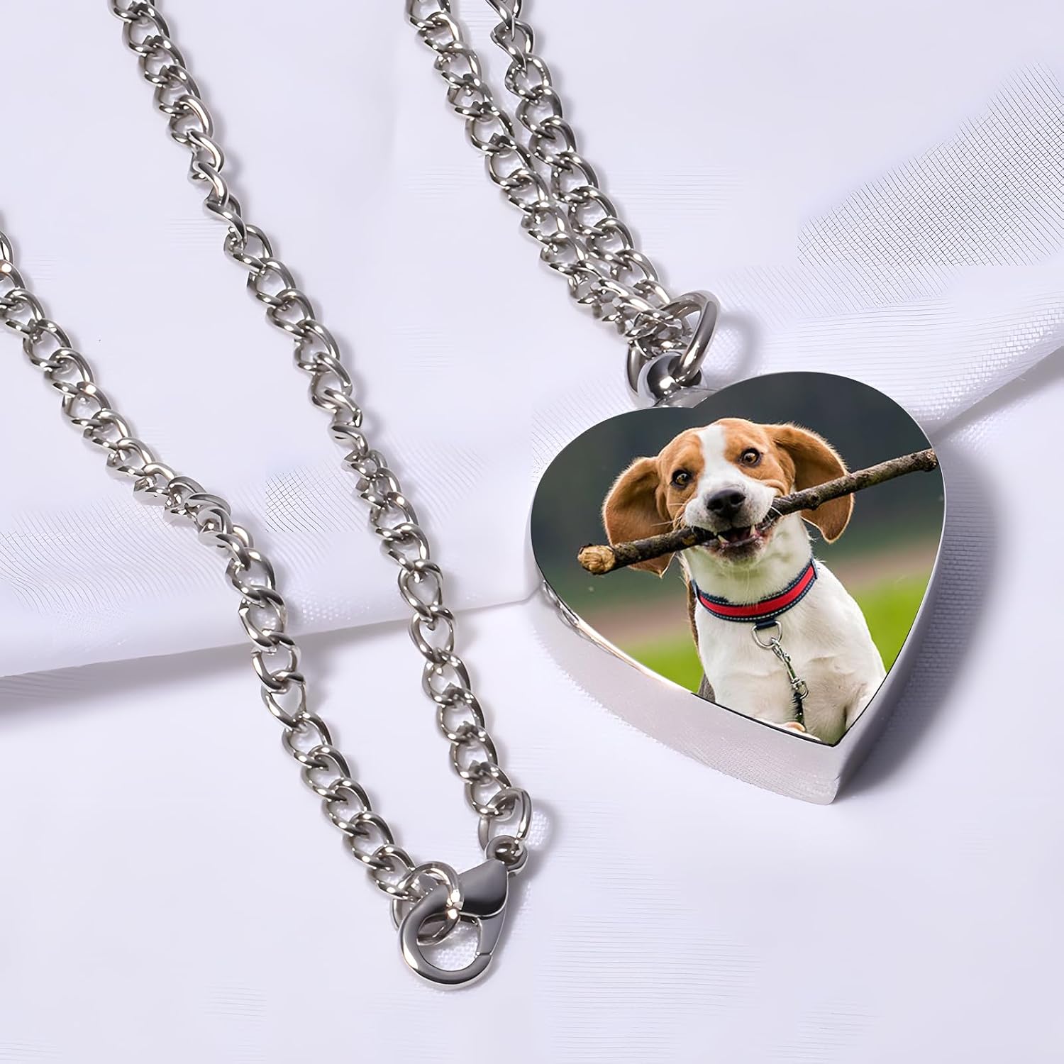HJX heart urn locket for ashes displayed with included miniature filling funnel and steel needle