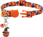 Close-up view of the Halloween themed pumpkin and witch hat pet collar bell clips.