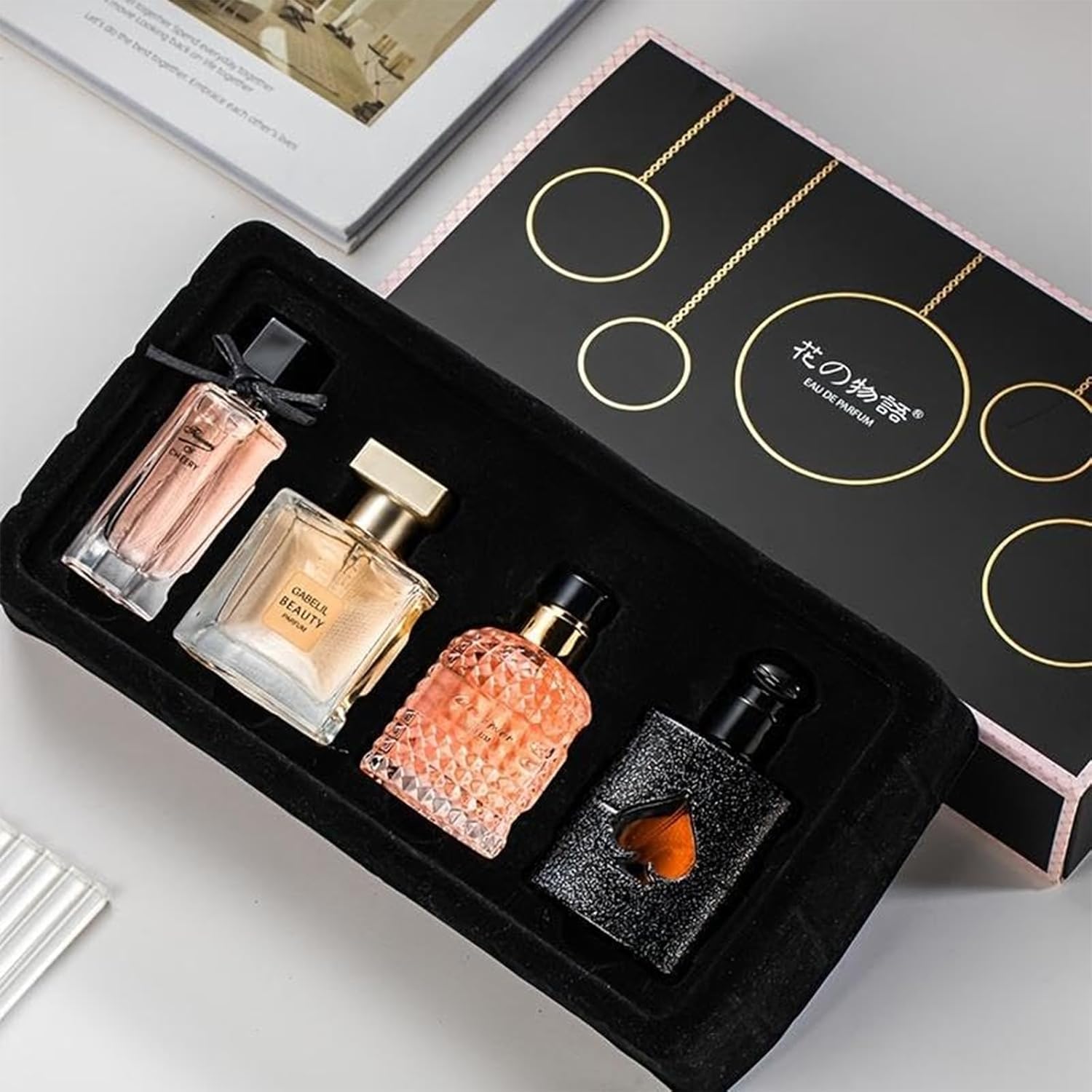 Gabelil Beauty Flower Stories Women Perfume Gift Set front view displaying four unique bottles inside the black presentation box.