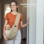 Human carrying a small puppy in a JourCraf hands-free sling