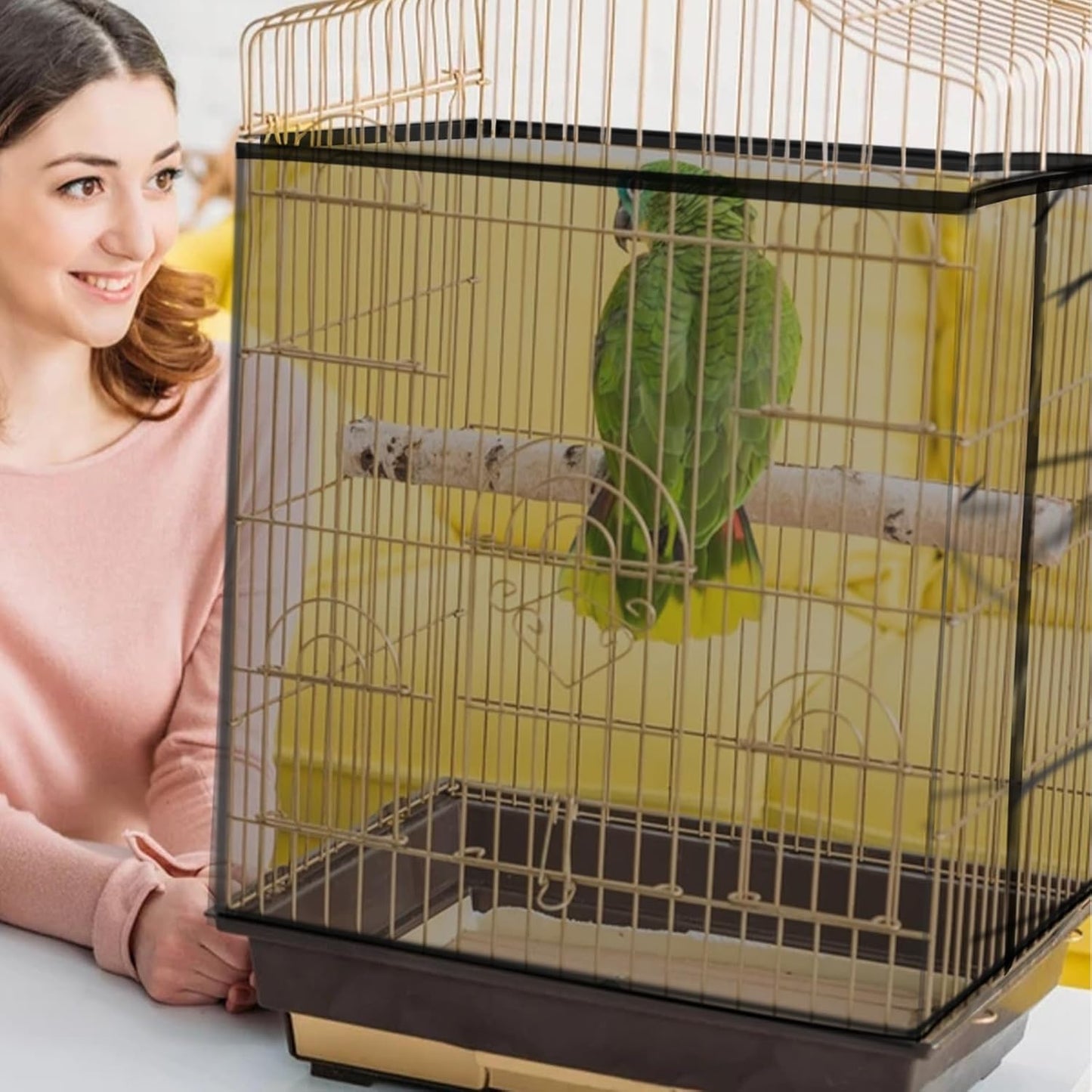 Bird cage skirt protector by Daoeny stretching around a large square wrought iron parrot cage