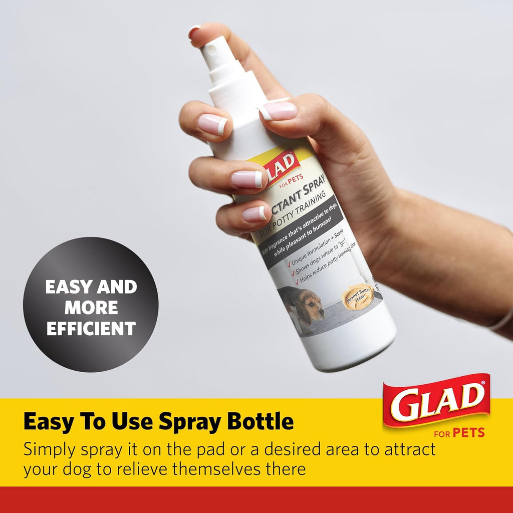Pet owner spraying Glad attractant on indoor training pad