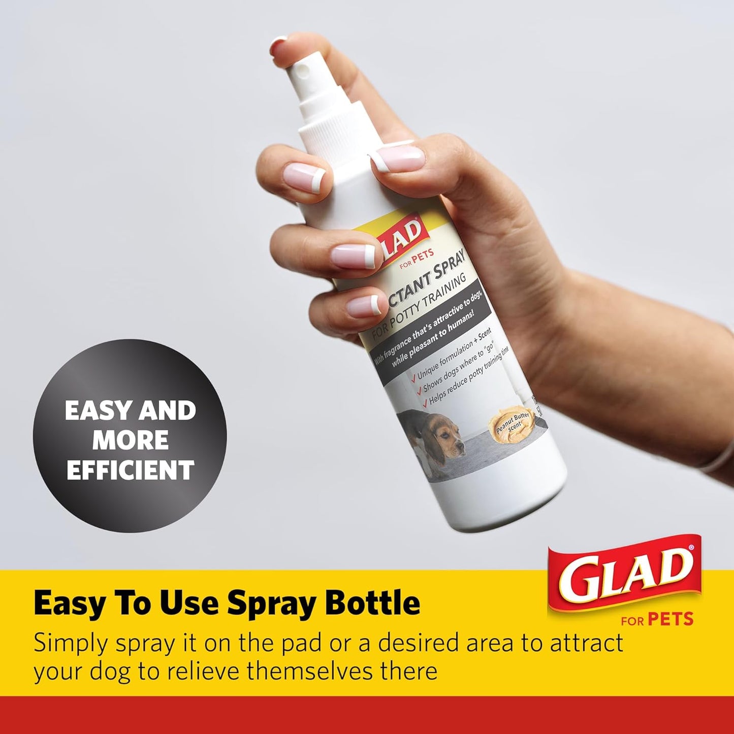 Pet owner spraying Glad attractant on indoor training pad