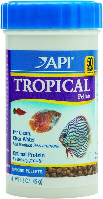 Container of API Bottom Feeder Pellets beside aquarium water