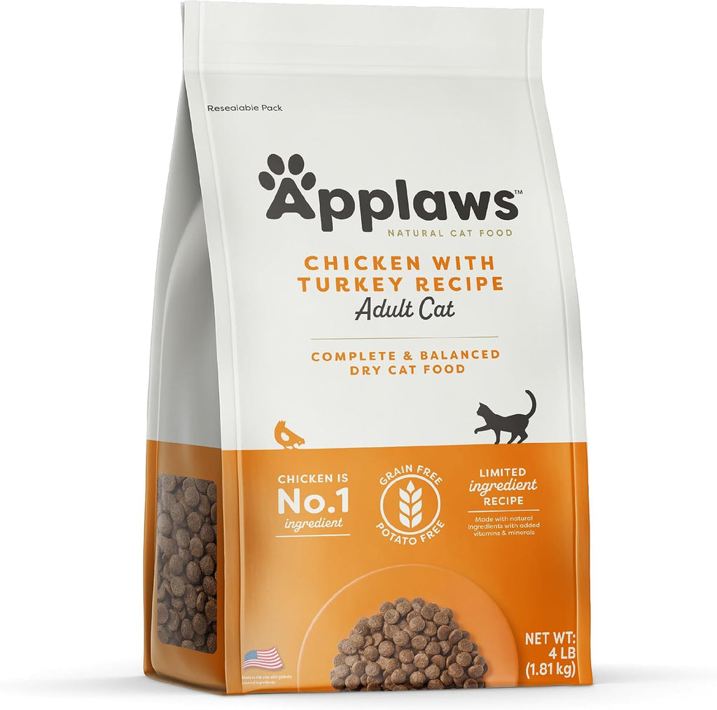 Happy adult cat sitting beside Applaws cat food package