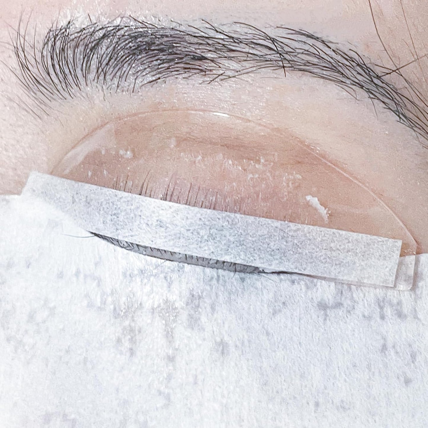 PERMANIA Lash Lift Paper Strips front view showing the premium white perming ribbons in a transparent storage box.