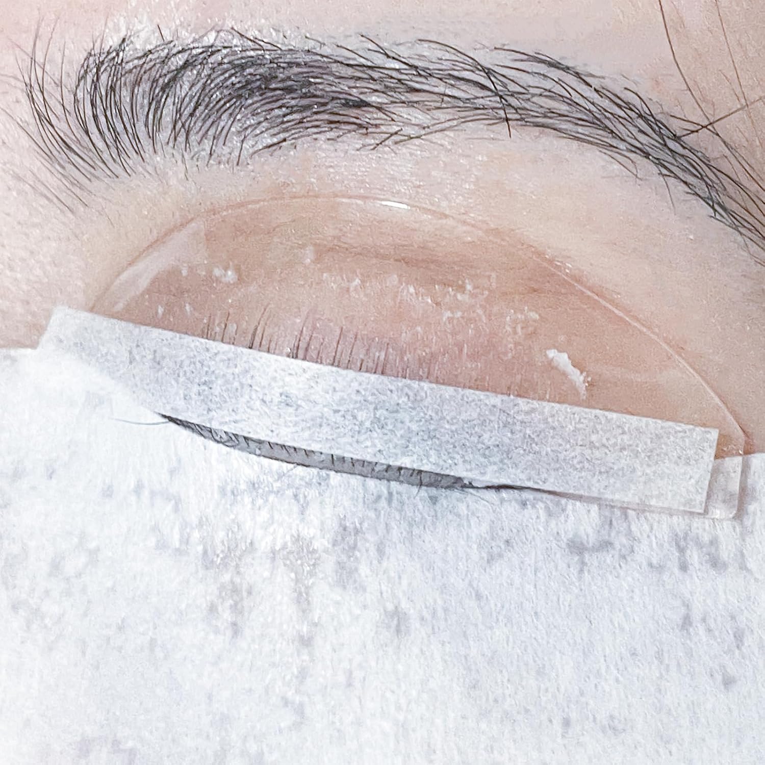 PERMANIA Lash Lift Paper Strips front view showing the premium white perming ribbons in a transparent storage box.