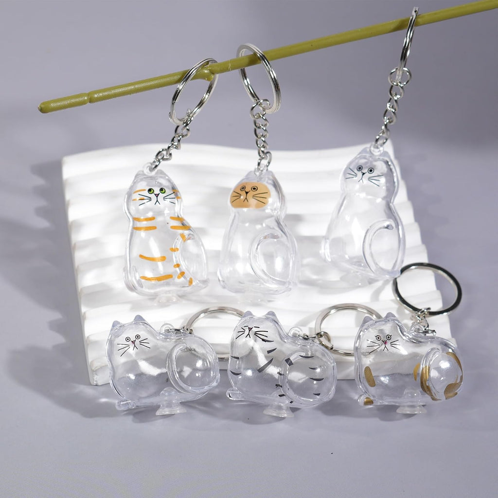 BTYYIHEX pet loss memorial keychain capsule being filled with a tuft of cat fur using tweezers close up view.