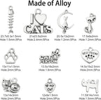 Variety of cat-themed Tibetan silver charms on a white background