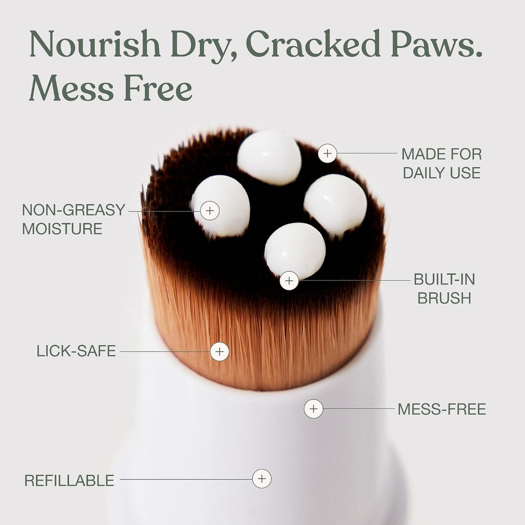 Dandylion dog paw lotion being applied to dry cracked dog paw pads with the mess-free brush