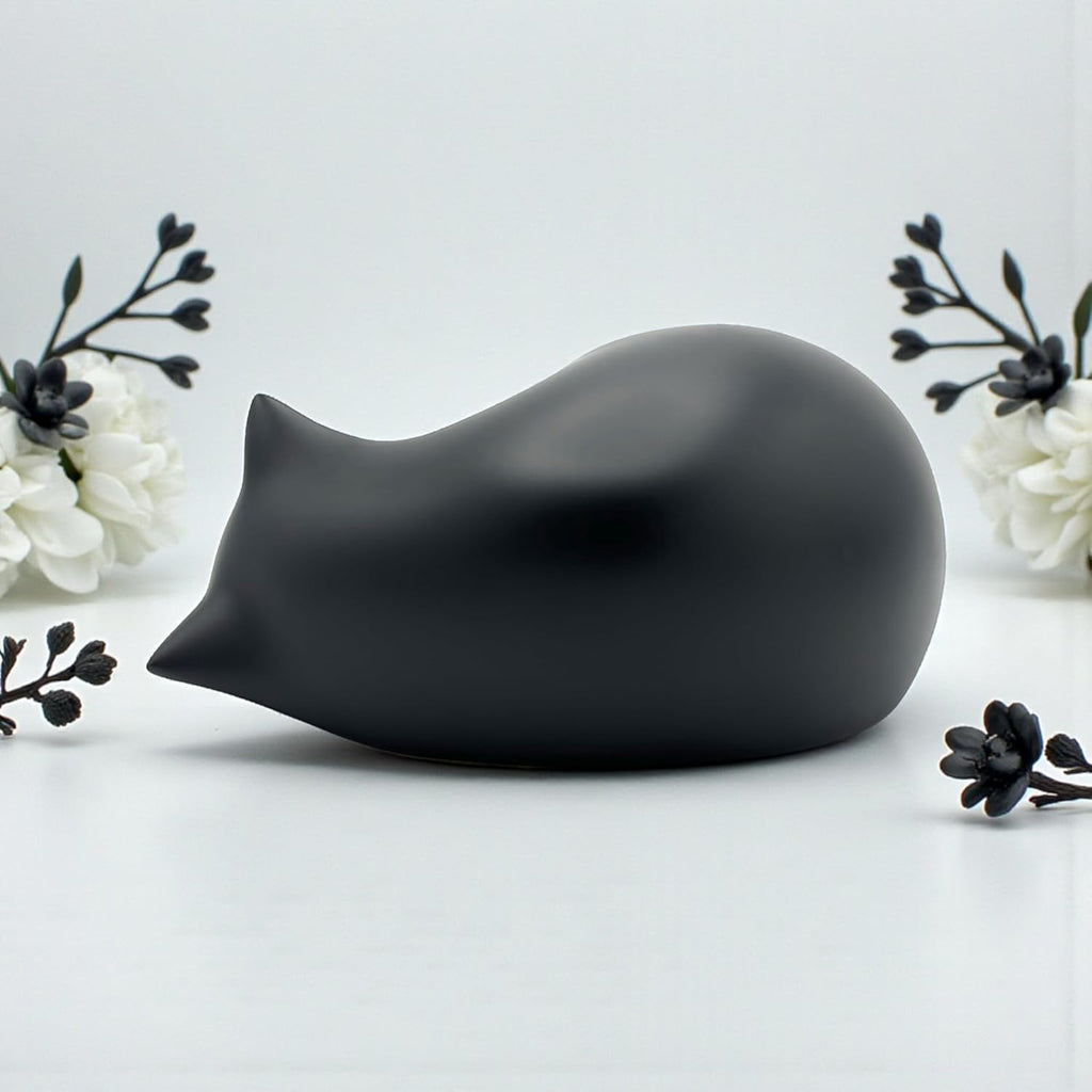 Comemori sleeping cat animal ashes container alongside the included airtight preservation pouch
