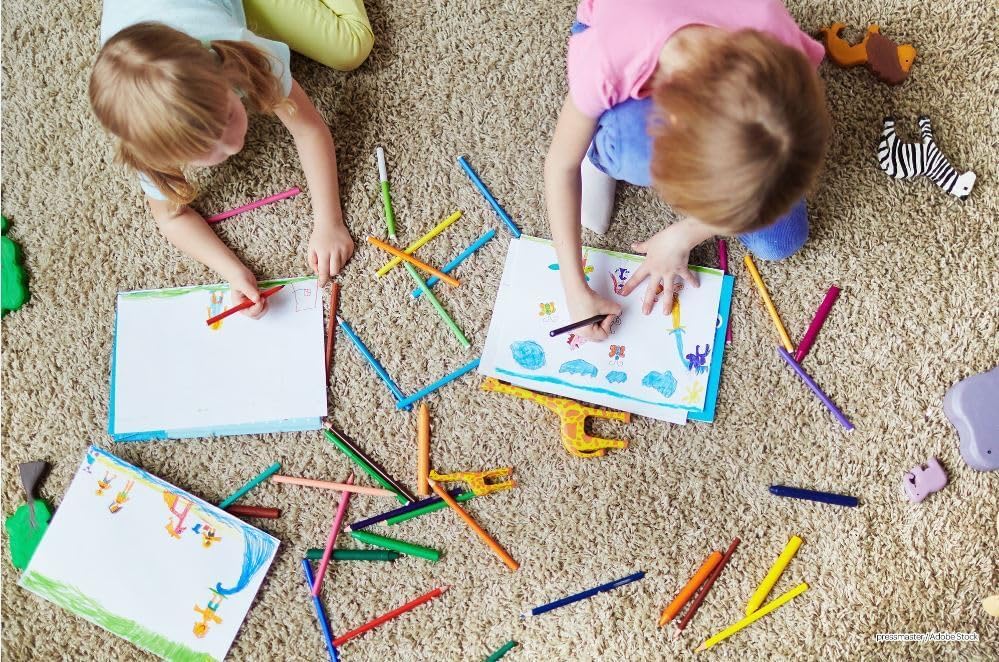Bendon Gabby's Dollhouse activity book being used by a child with colorful crayons on a table.