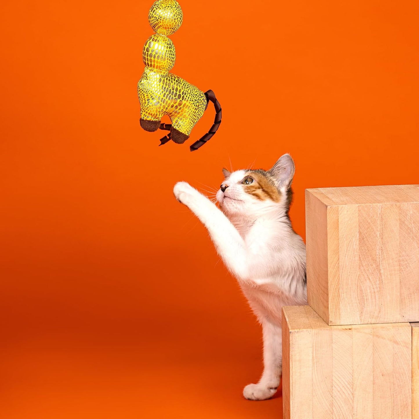 Fringe Studio catnip kicker toy showcasing the shiny spotted fabric and reflective details.