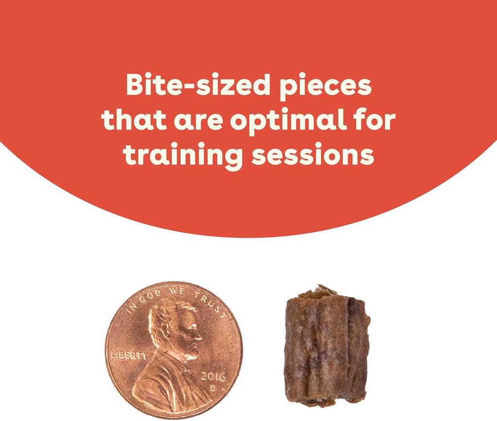 Dog eating small soft training treat held in hand