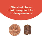 Dog eating small soft training treat held in hand
