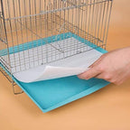 Stack of white precut bird cage paper mats on a wooden surface